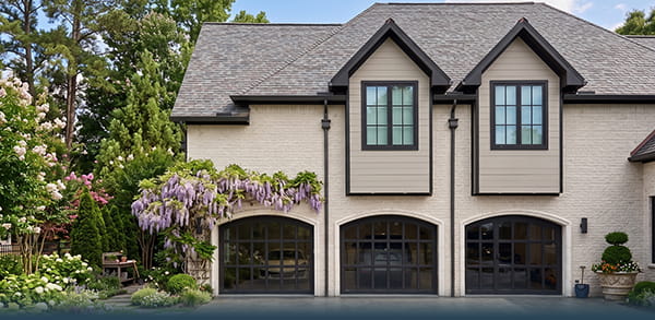 Three-car garage door installation in Manalapan, New Jersey, with custom residential garage doors