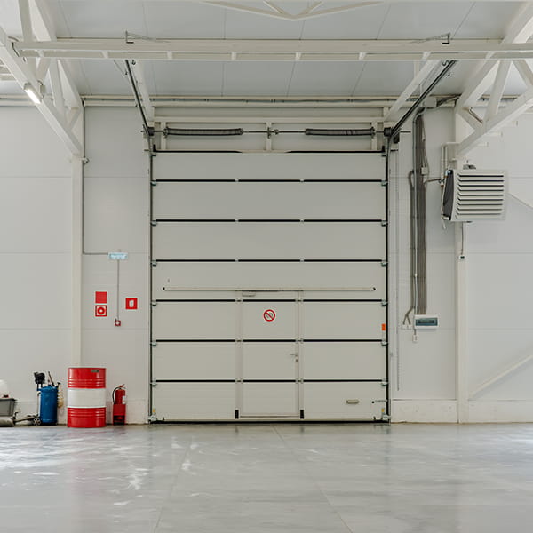 warehouse and distribution center with commercial garage doors and loading dock doors